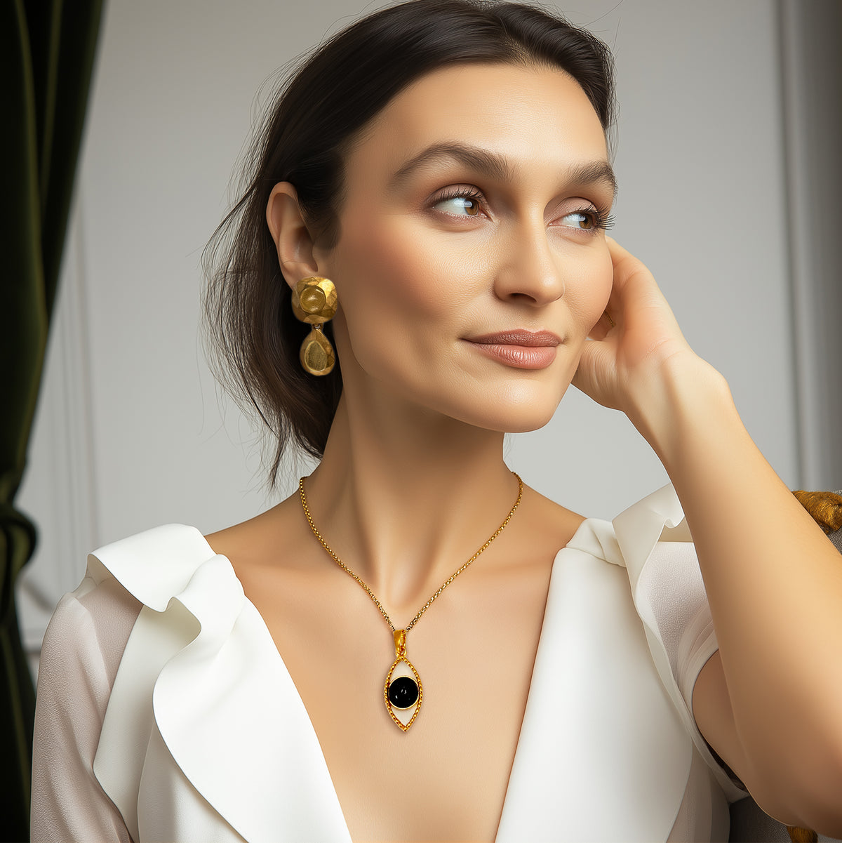 Model wearing Kenneth Jay Lane 22k gold plated cushion and pear drop earrings