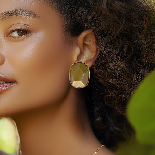 Model wearing bold Kenneth Jay Lane gold nugget clip-on earrings in sculptural form