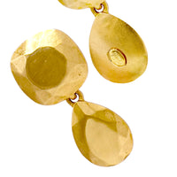 Close-up of Kenneth Jay lane geometric gold earrings front and back with sculpted texture