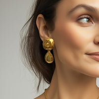 Model wearing Kenneth Jay Lane 22k gold plated cushion and pear drop earrings