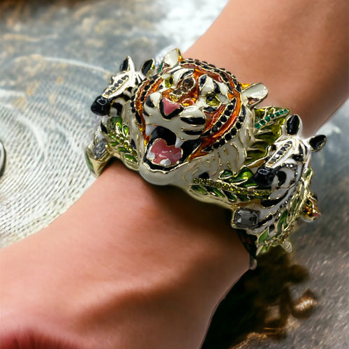 Elegant woman wearing a Ritzy Couture DeLuxe jungle animal charm bracelet by Esme Hecht.
