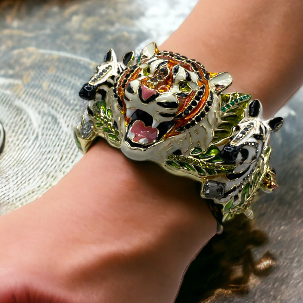 Elegant woman wearing a Ritzy Couture DeLuxe jungle animal charm bracelet by Esme Hecht.