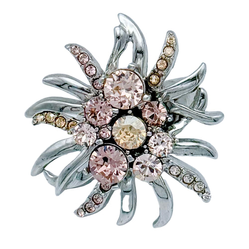 Oscar de la Renta abstract floral ring with peach Austrian crystals on display.