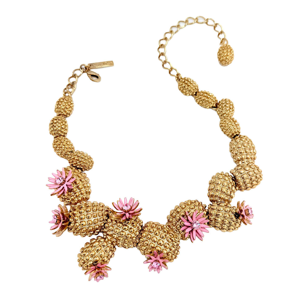 Full view of Oscar de la Renta cactus blossom necklace styled with matching earrings and a pink dress, highlighting its intricate details.