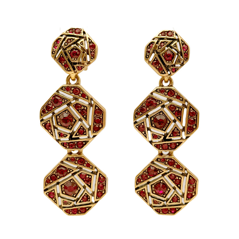 Close-up of Oscar de la Renta's antique gold earrings featuring red Siam Austrian crystals in a mosaic design, showcasing geometric elegance.