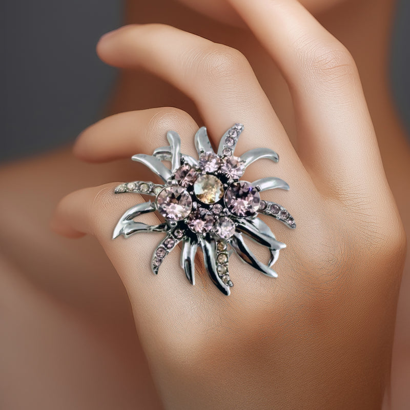 Oscar de la Renta peach crystal ring worn on hand, showing bold floral design.