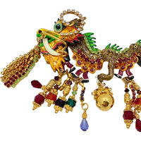 Front view of Lunch at The Ritz Year of the Dragon Parade Brooch, featuring gold-tone enamel, vibrant crystals, and articulated sections.