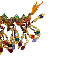 Front view of Lunch at The Ritz Year of the Dragon Parade Brooch, featuring gold-tone enamel, vibrant crystals, and articulated sections.