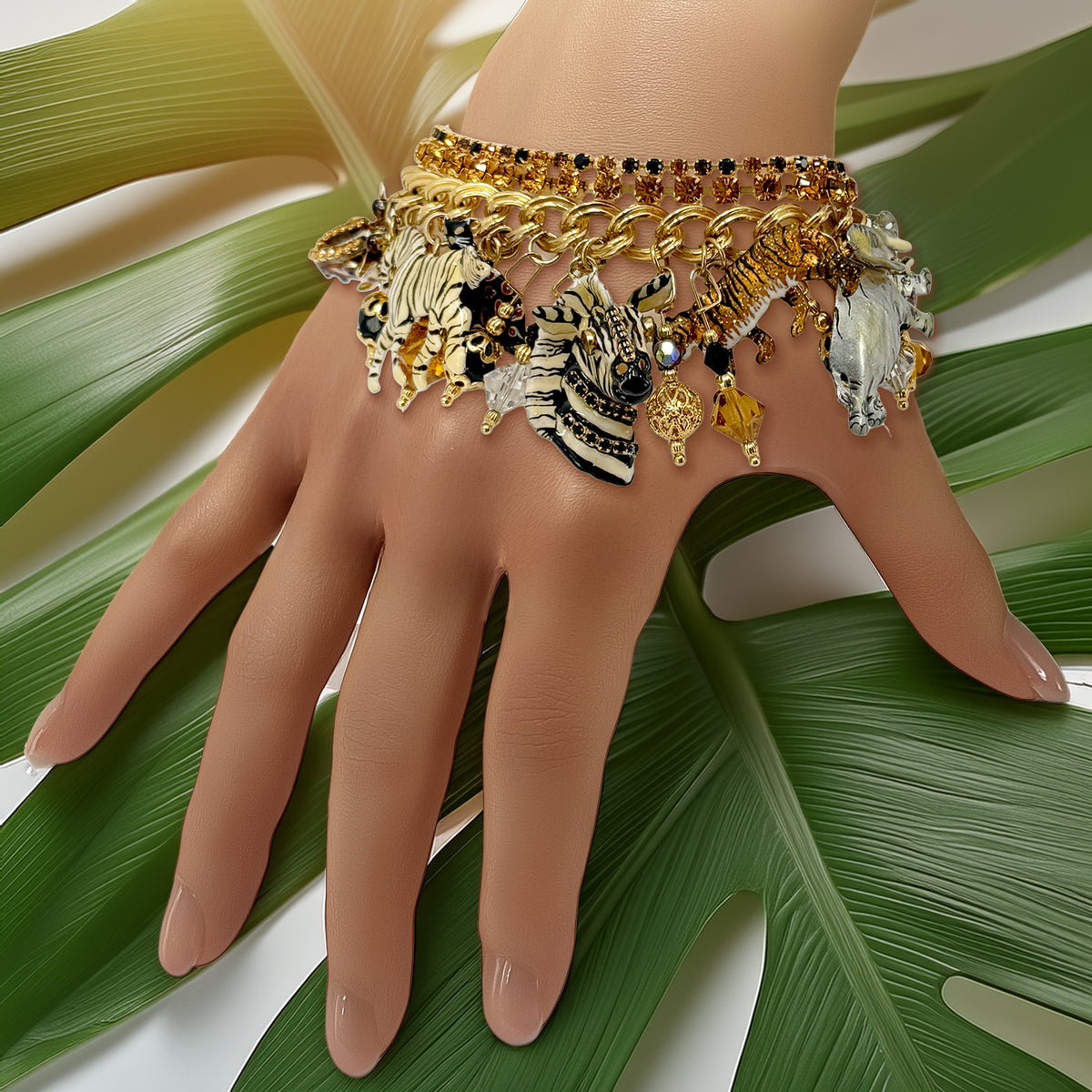 The Lunch at The Ritz Jungle Safari Bracelet displayed on a hand, highlighting its luxurious 22K gold finish and bold, whimsical charm design.