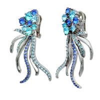 Front view of Oscar de la Renta silver-plated post earrings with aquamarine and sapphire-colored crystals, featuring a squid-inspired flowing tentacle design.