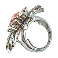 Oscar de la Renta abstract peach crystal ring modeled, showcasing elegant artistry.
