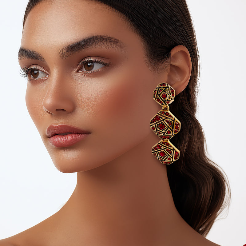 Model wearing the earrings, emphasizing their bold statement style and radiant red crystal accents.