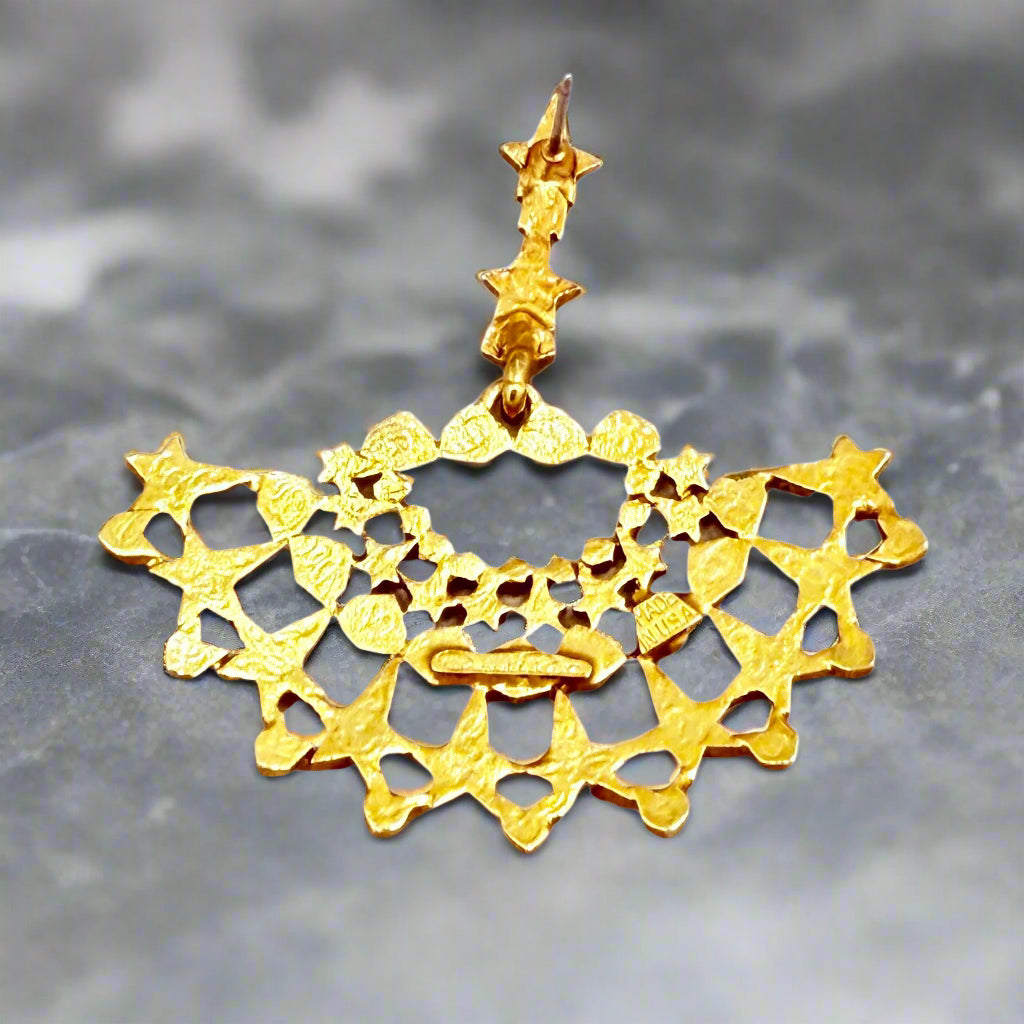 Flatlay view of the Oscar de la Renta gold fan earrings, highlighting their 2" x 2" dimensions and sculptural star motif.